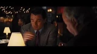two men drinking wine in dimly lit restaurant — The Wolf Of Wall Street