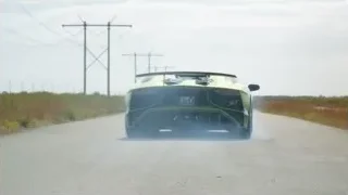 Green sports car driving on highway — Sports Cars