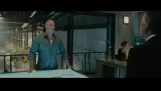 Two men discussing blueprint in room — Furious Seven