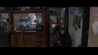 man sitting in dimly lit room with flag — Southpaw
