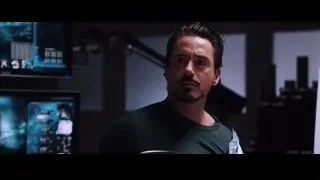 man holding object in front of large screen — Iron Man