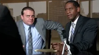 two men conversing at office desk — Suits