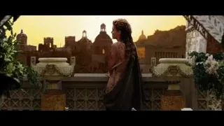 Woman in flowing dress on balcony overlooking city — Gladiator