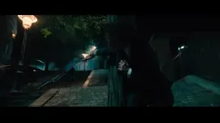 person crouching on stairs in dark alleyway — John Wick: Chapter 4
