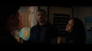 three people conversing in room with globe — Creed 3