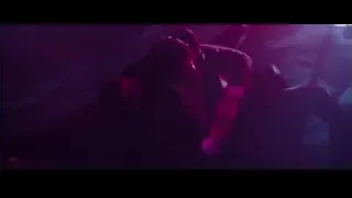 person playing guitar on stage — John Wick