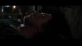 man lying on back in dimly lit room — Batman: The Dark Knight Rises