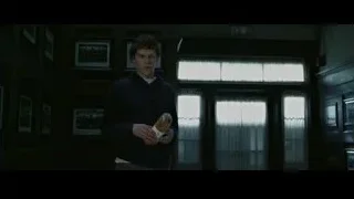 young man with sandwich in dilapidated room — The Social Network