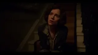 Young woman sitting on staircase in dimly lit room — Peaky Blinders