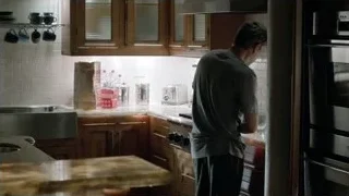 Man in kitchen looking at phone — Suits