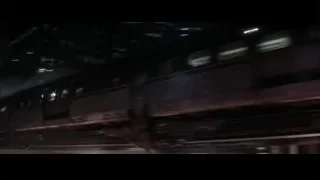 train moving through city at night — Batman
