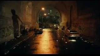 Street at night under archway with city skyline — Joker