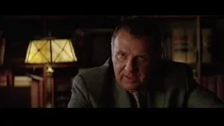 man sitting at desk in dimly lit room — Batman