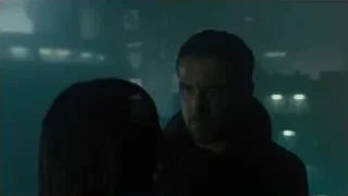 man and woman with city skyline at night — Blade Runner 2049