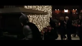 woman dancing at dimly lit formal event — Batman: The Dark Knight