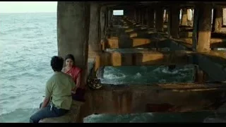 man and woman on pier looking at ocean — Life of Pi