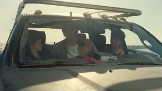 Three people sitting in old rusted car — Interstellar