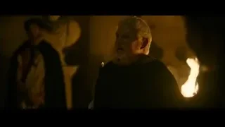 elderly man in dimly lit room with fire — Gladiator 2