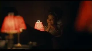 woman sitting with red lamps — Joker