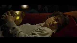 young man on red couch with golden trophy — Harry Potter and the Goblet of Fire