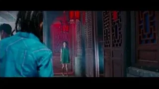 woman in green dress in red lantern alleyway — The Karate Kid