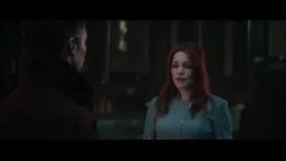Man and red-haired woman with microphone in dimly lit room — Doctor Strange 2