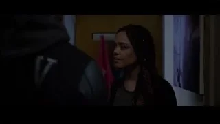 man and woman in dimly lit hallway — Creed