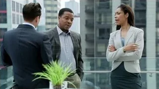 three people conversing on balcony — Suits