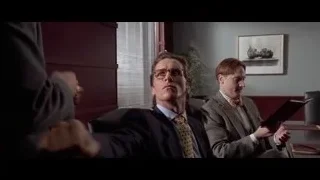 two men in suits looking at tablet — American Psycho