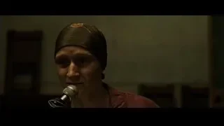 woman speaking into microphone in dim room — Fight Club