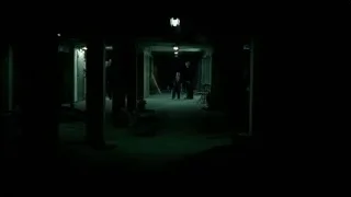 People in dimly lit abandoned building hallway — Breaking Bad