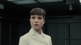 young woman looking at camera in dark room — Blade Runner 2049