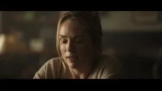 Woman with serious expression in dimly lit room — F1