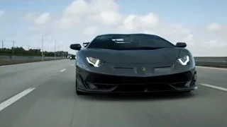 black Lamborghini Huracan driving on highway — Sports Cars