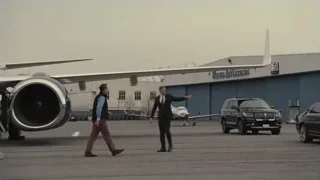 Black SUV parked by Ross Aviation hangar — Succession