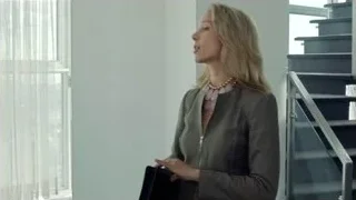 woman in office with staircase — Suits