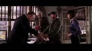 man in suit holding red scarf in office — Spider Man 2