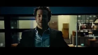 man in dark suit in dim room — Limitless