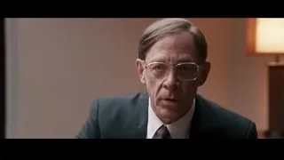older man in suit with serious expression — Jobs