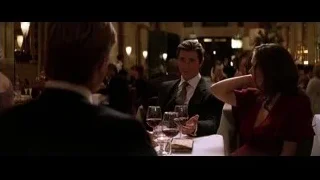 man and woman conversing at restaurant table — Batman: The Dark Knight