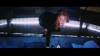 Red-haired woman leaning over desk with computer — Iron Man