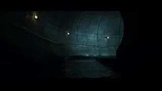 person standing in dark tunnel with water — The Amazing Spider Man