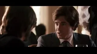 man in suit sitting at table with wine — Jobs