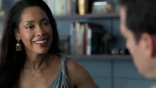 woman smiling with man by bookshelf — Suits