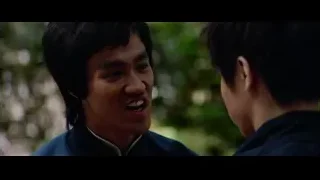 Two men conversing in outdoor setting — Bruce Lee: Enter The Dragon