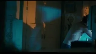 Distressed woman in dimly lit room — Joker