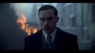 man in suit standing before raging fire — Peaky Blinders