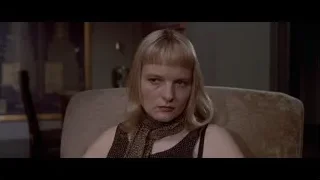 woman sitting upset in living room — American Psycho