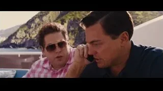 Two men conversing on boat overlooking ocean — The Wolf Of Wall Street