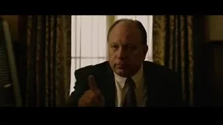 Man in suit sitting and pointing finger — The Social Network